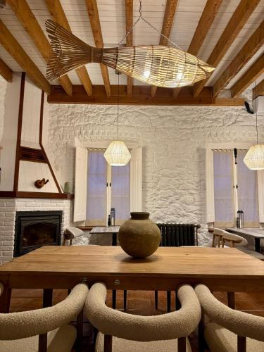 a dining room table with a vase on top of it at Hotel Quinta Solera in Oviedo