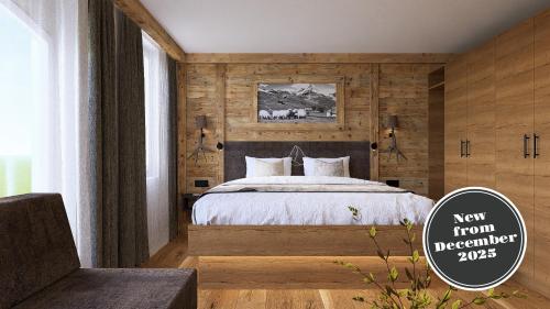 una camera da letto con un letto con una parete in legno di La Perle Apartments a Zermatt