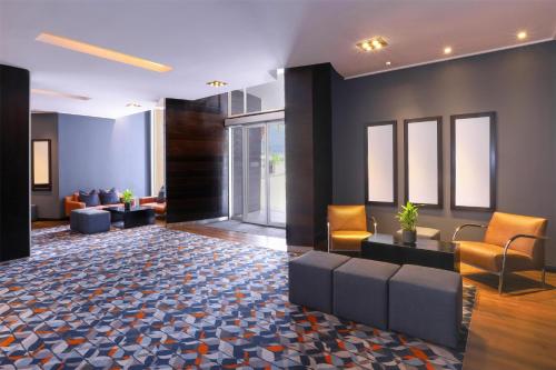 a lobby of a hotel with couches and chairs at Southern Sun Newlands in Cape Town