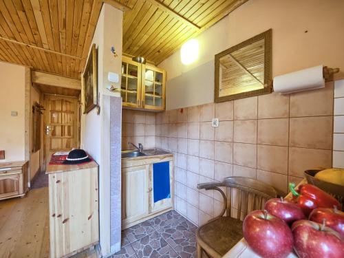 a kitchen with a bowl of apples on a table at Oremusówka in Zakopane