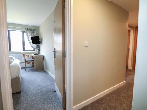 a hallway with a door leading to a room at Seashell Suite at Marine Court in Littlehampton
