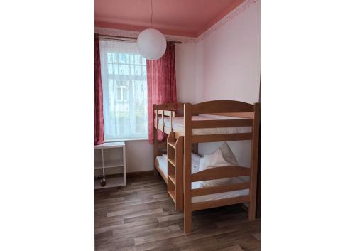 a bedroom with two bunk beds and a window at KOS - Haus Netti in Koserow
