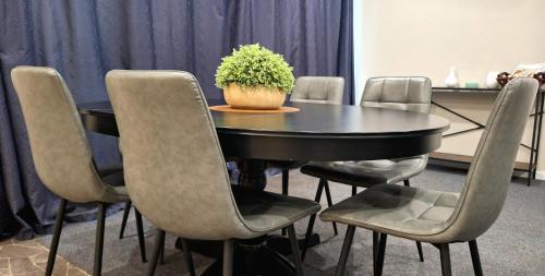 a black table with chairs and a potted plant on it at Lyndoch Retreat, 2BR with Pool, BBQ & Fire Pit in Altona