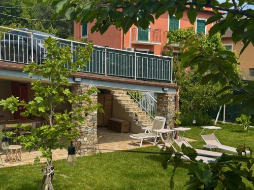 a house with a balcony and a patio at Ligo in Villanova dʼAlbenga