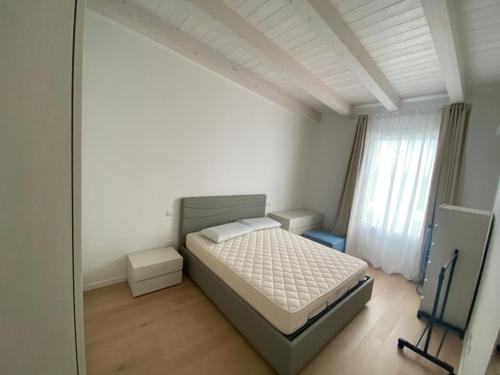 a bedroom with a bed and a large window at Wave Island in Lido di Jesolo