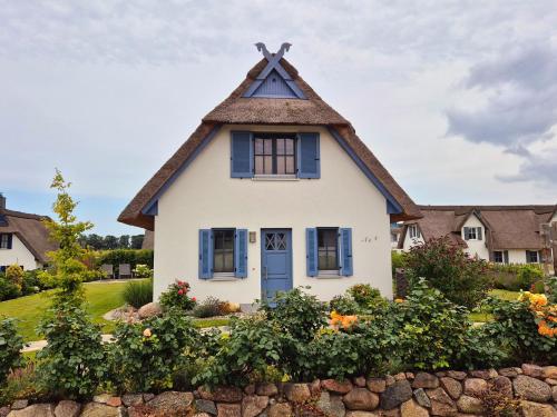 a white house with a thatched roof at Reethaus "Dat Lavendelhus" in Zierow