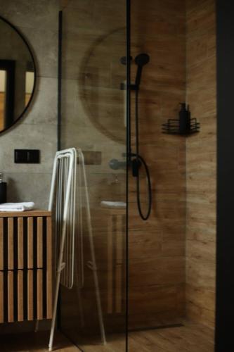 a shower with a glass door in a bathroom at Rowerowa Przystań in Milicz