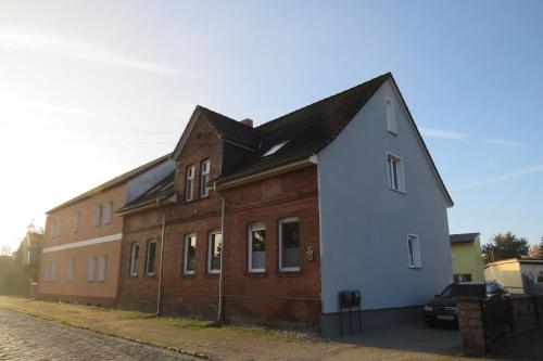 a large brick building with a black roof at Ferienwohnung Wilhelmine in Mosigkau