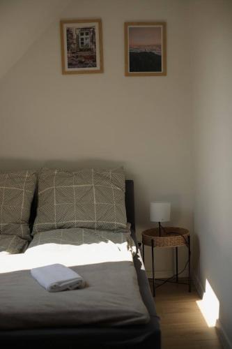 a bedroom with a bed and a table with a lamp at Rowerowa Przystań in Milicz