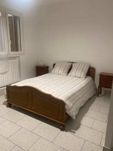 a bedroom with a large bed in a room at Warm and fully equipped studio in Aubervilliers
