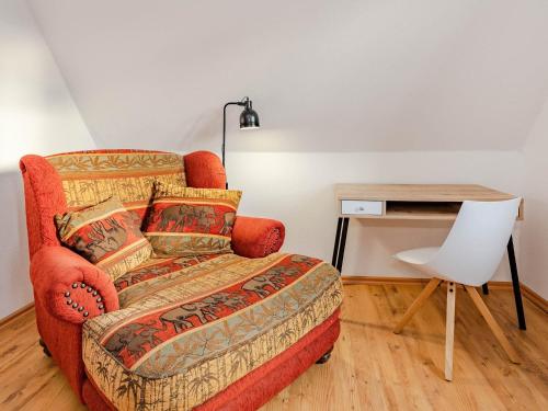 a living room with a couch and a desk at Haus Hornhecht in Kamminke