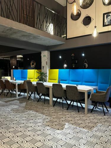 a lobby with tables and chairs in a building at NORD Up in Zalău