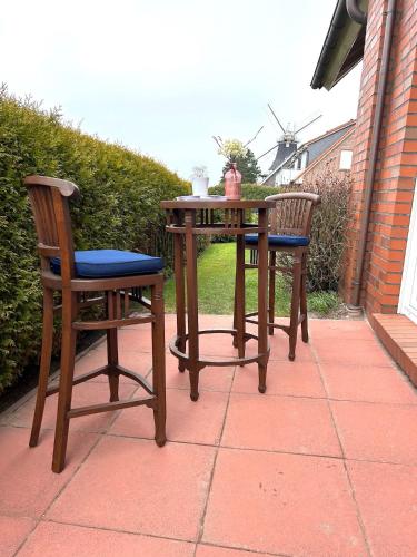 a table and two chairs on a patio at Deichwärts in Carolinensiel