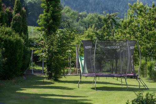 a chair in the grass in a park at Gartenhof in Brixen