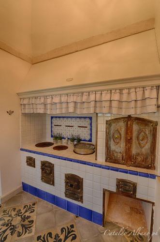 a bathroom with two sinks and blue and white tiles at Masseria Luco in Martina Franca