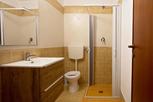 a bathroom with a toilet and a sink and a shower at Casa Atena in Motta D'affermo