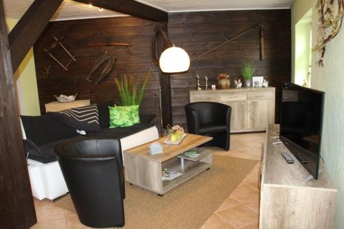 a living room with a couch and a table at Inas Spreewaldstube in Vetschau