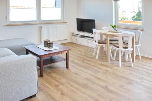 a living room with a couch and a table and a tv at Ferienwohnung Lischka in Lübbenau
