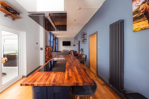 a kitchen with a wooden counter top in a room at Luxury Seaview Cottage by Fairy Pools 2 in Carbost