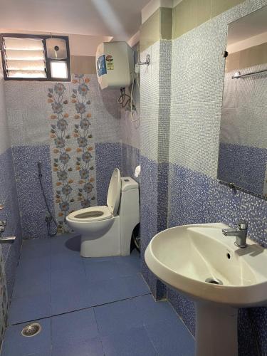 a bathroom with a toilet and a sink at Hotel Oak in Namchi