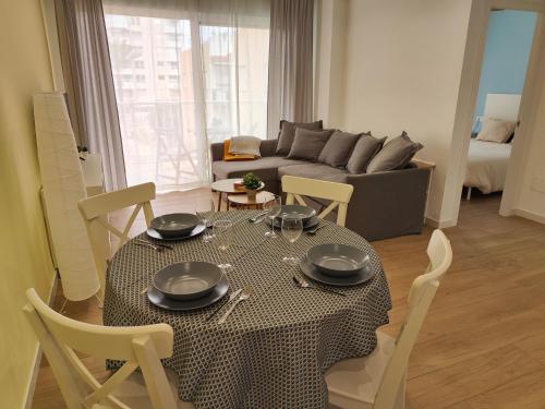 a living room with a table and a couch at Apartamento La Casica Beach Poniente in Águilas
