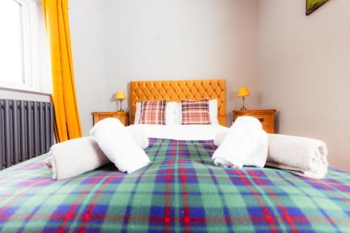 a bedroom with a bed with two stuffed animals on it at Luxury Seaview Cottage by Fairy Pools 2 in Carbost
