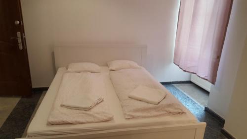 a bed with two pillows on it in a room at Cozy Central Retreat in Budapest