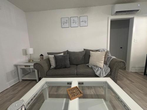 a living room with a couch and a glass table at 3 miles to Ft Benning - Cozy Family Retreat in Columbus