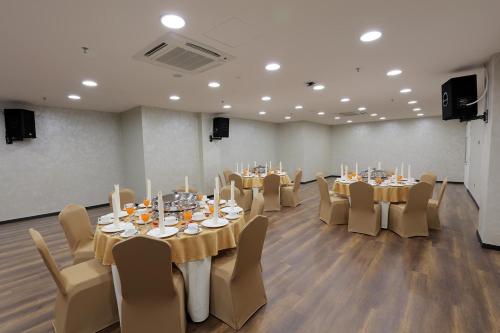 a conference room with tables and chairs with candles at Amerin Hotel Johor Bahru in Johor Bahru