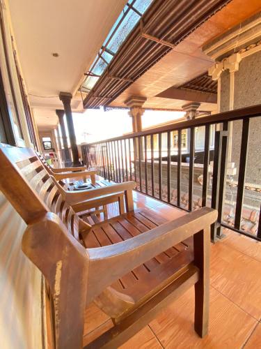 a wooden bench sitting on top of a balcony at ABI Hotel2 - 1 minute to the Beach and 1 second to the Mall in Ngurah Rai International Airport