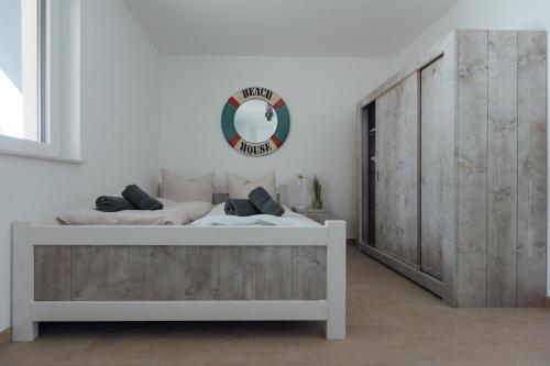 a bedroom with a bed and a mirror on the wall at Exklusive Ferienwohnungen an der Havel in Werder
