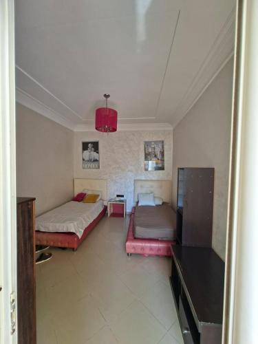 a living room with two beds and a table at Appartement vu sur Mer in Mohammedia
