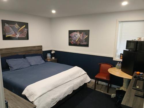 a bedroom with a bed and a table and a chair at Aurora Nights in Fairbanks