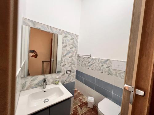 a bathroom with a sink and a mirror at Pompeano House in Mazara del Vallo