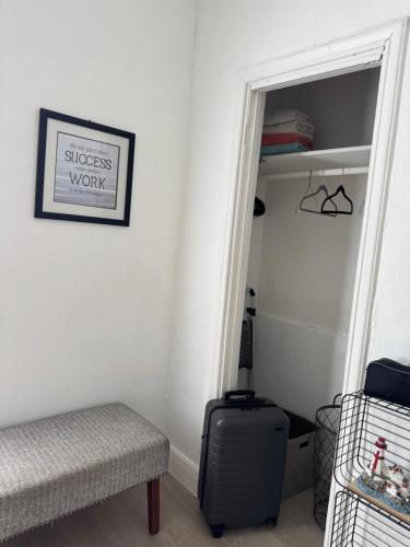 a room with a suitcase sitting next to a doorway at Charming Historic Home with Modern Comforts in Opa-locka