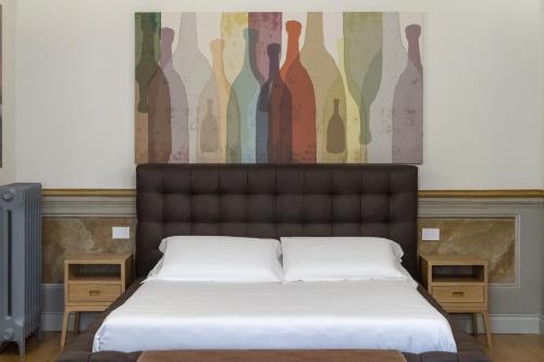 a bedroom with a bed and a painting on the wall at Palazzo Sapori in Soriano nel Cimino