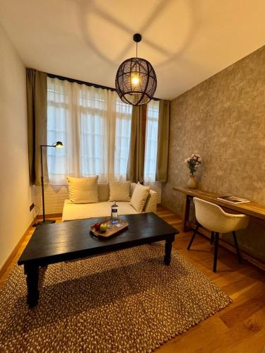 a living room with a couch and a table at Hotel Quinta Solera in Oviedo