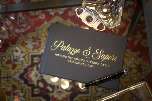 a table with a pen and a sign on it at Palazzo Sapori in Soriano nel Cimino