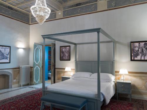 a bedroom with a canopy bed and a fireplace at Palazzo Sapori in Soriano nel Cimino