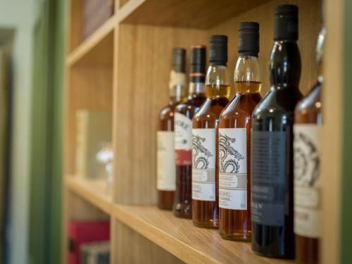 a row of wine bottles sitting on a shelf at Palazzo Sapori in Soriano nel Cimino