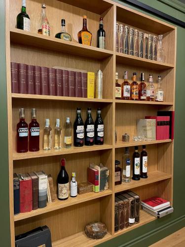 a shelf filled with lots of bottles of alcohol at Palazzo Sapori in Soriano nel Cimino