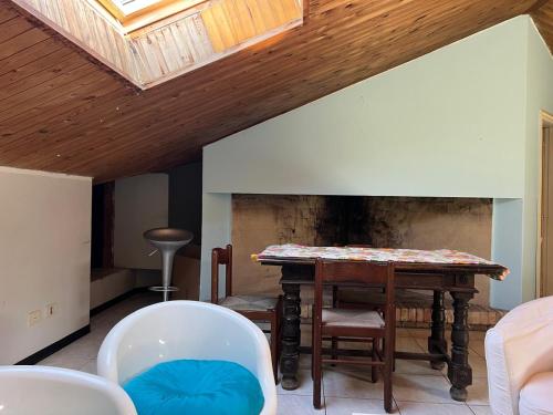 a living room with a table and chairs at La Casa dei Pini in Porto San Giorgio