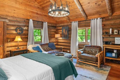 a bedroom with a bed and a chandelier at North 40 Lodge and Cabin in Clarkesville