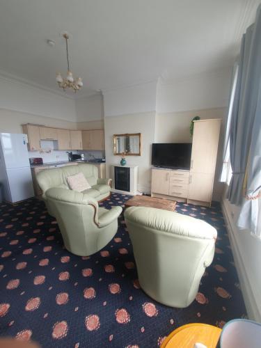 a living room with two chairs and a couch at Manhattan Lodge in Lytham St Annes