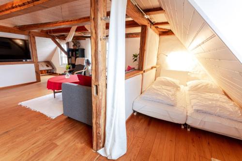 a bedroom with a bed and a table in a room at Ferienwohnungen Klein Kapelle in Gingst