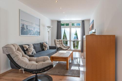 a living room with a couch and a table at Ferienwohnung 11 Villa Eden in Binz