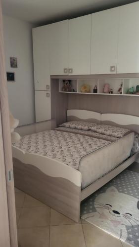 a bedroom with a large bed with white cabinets at Apartment Gaia in Nardò