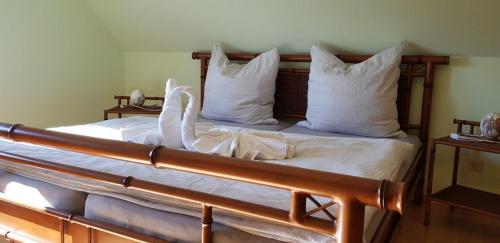 a bedroom with a bed with white sheets and white pillows at Ferienwohnung "Safari" in Liepgarten