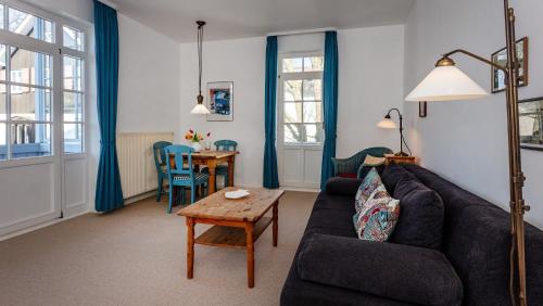 a living room with a couch and a table at Villa Ruscha in Binz