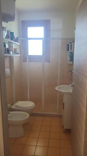 a bathroom with a shower and a toilet and a sink at Apartment Gaia in Nardò